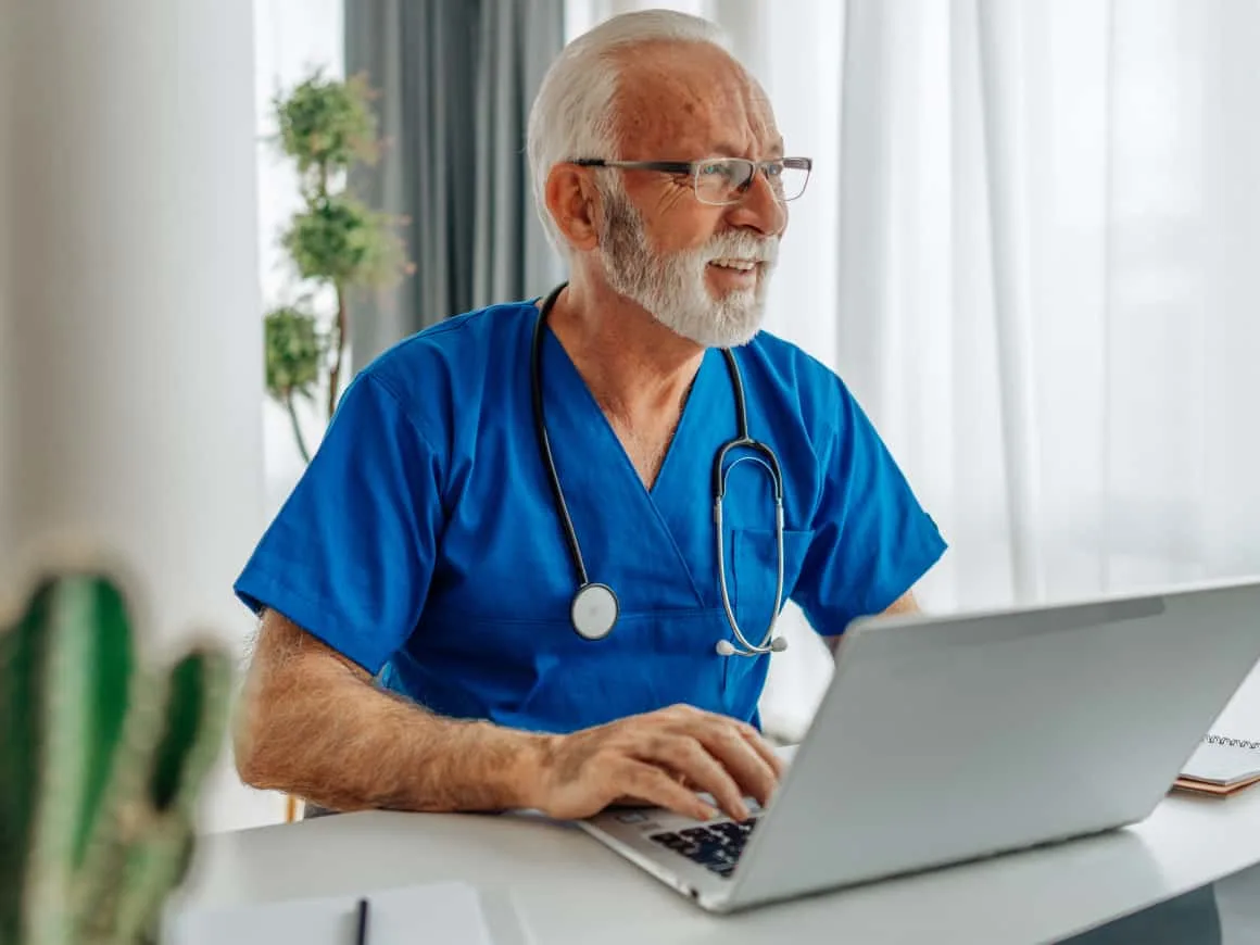 Elderly male physician computer stethoscope Benefit
