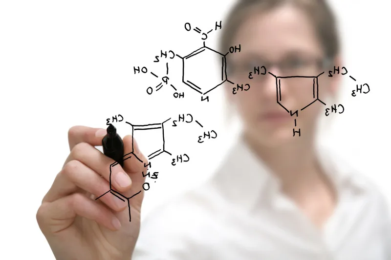 Researcher writing a chemical formula 