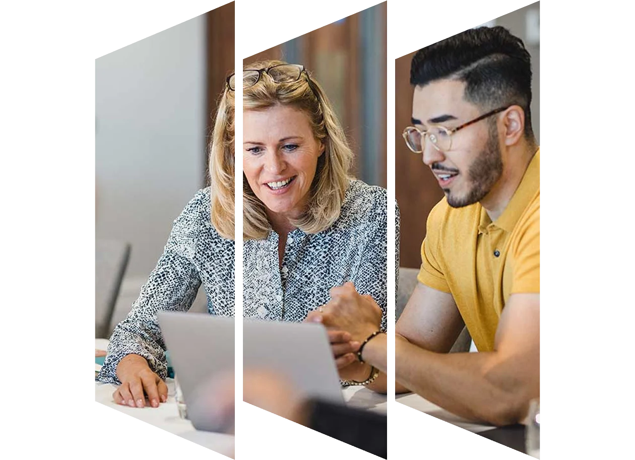 Colleagues looking at a laptop discussing something