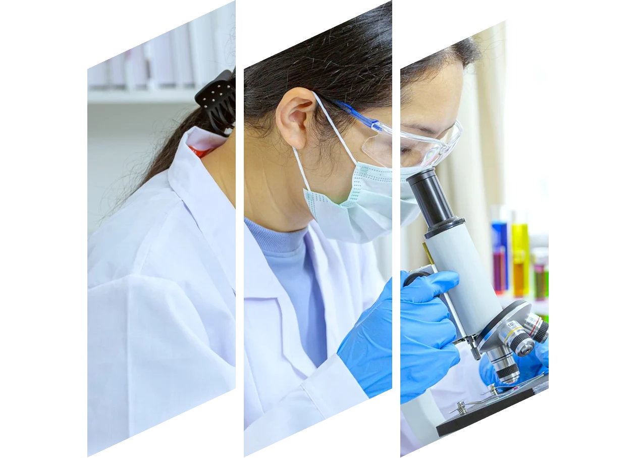 Side view of female scientist looking at test sample through microscope in laboratory