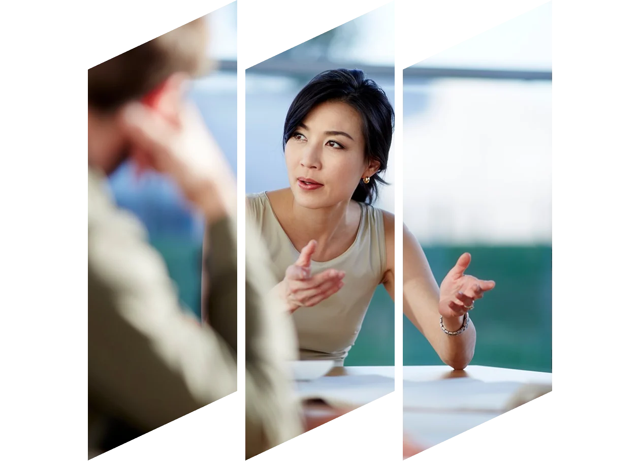 Two women colleagues walking, talking and holding clipboards