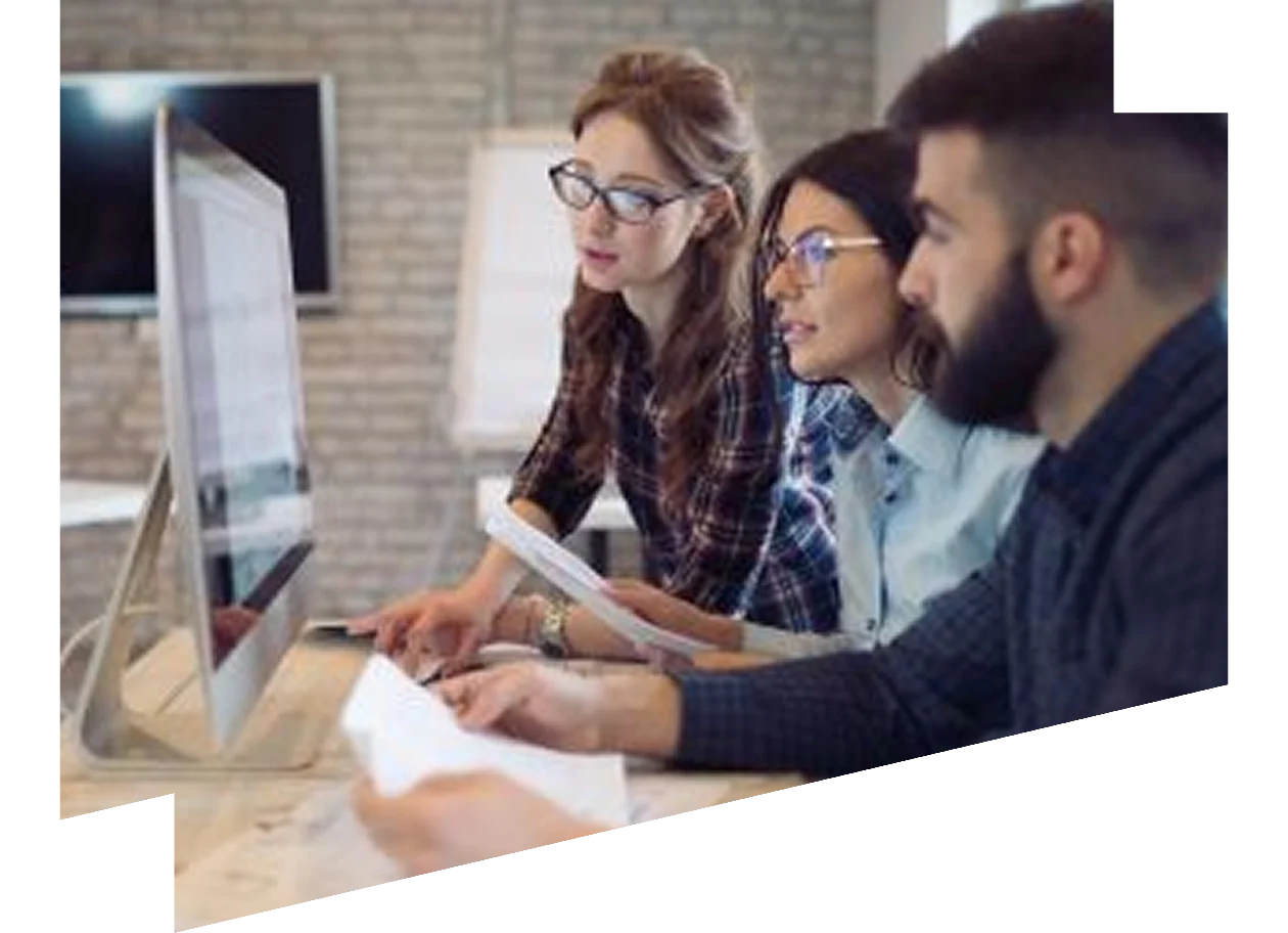 Group of colleagues looking at a screen together in a meeting room