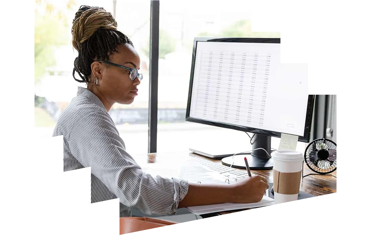 African woman taking notes from computer screen