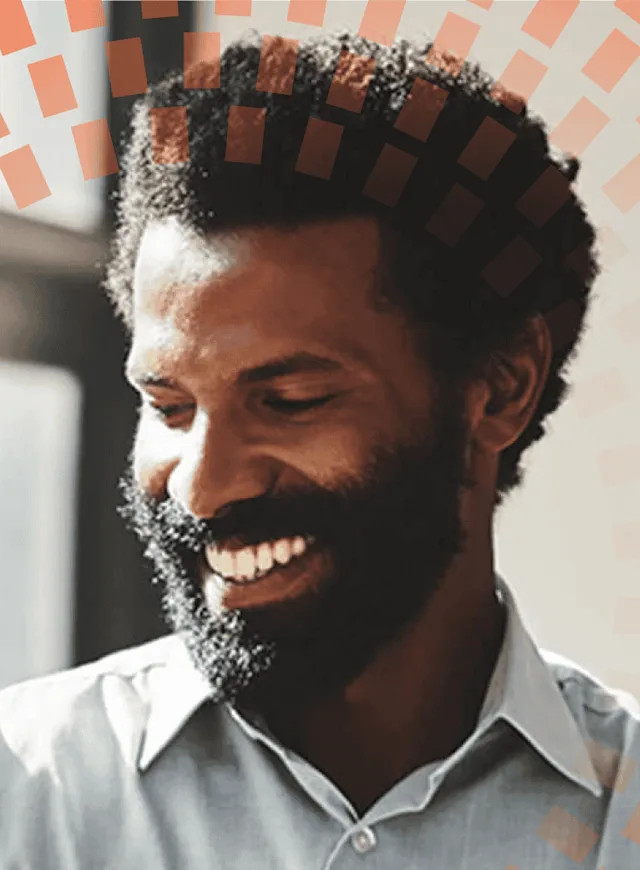 Man smiling next to window