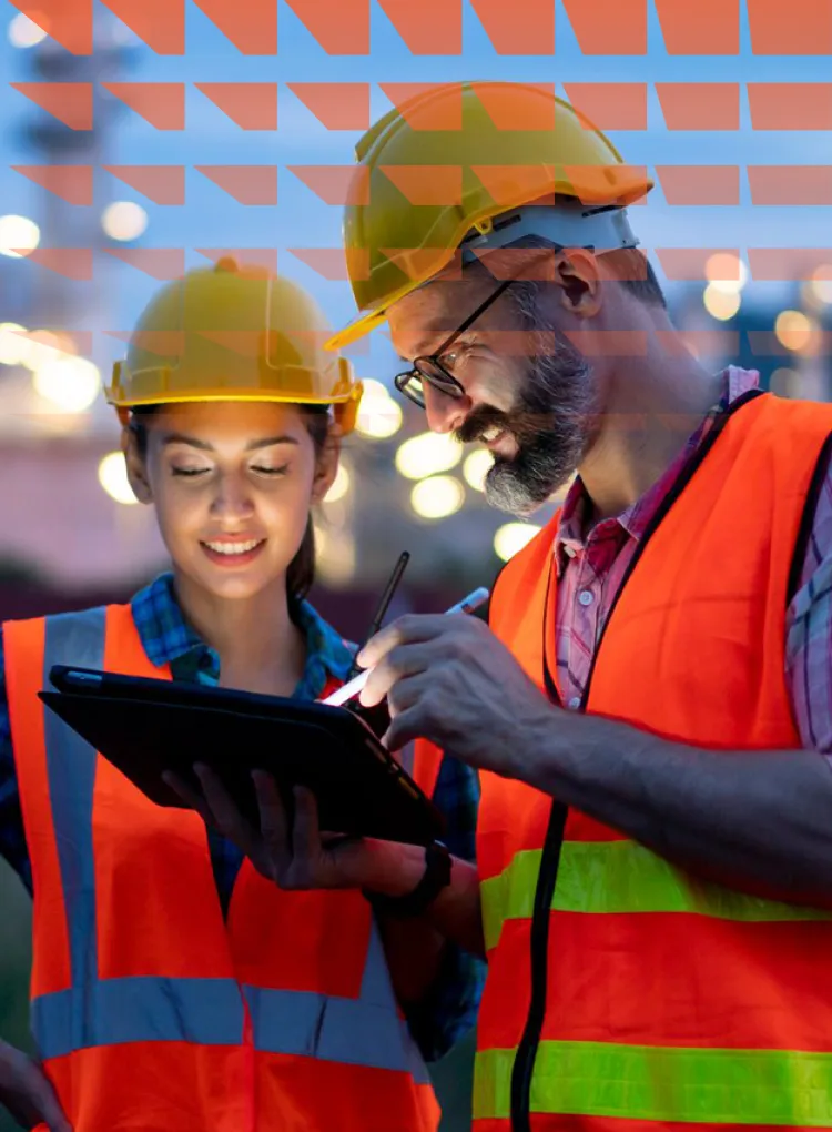 Engineers using tablet near oil refinery at night