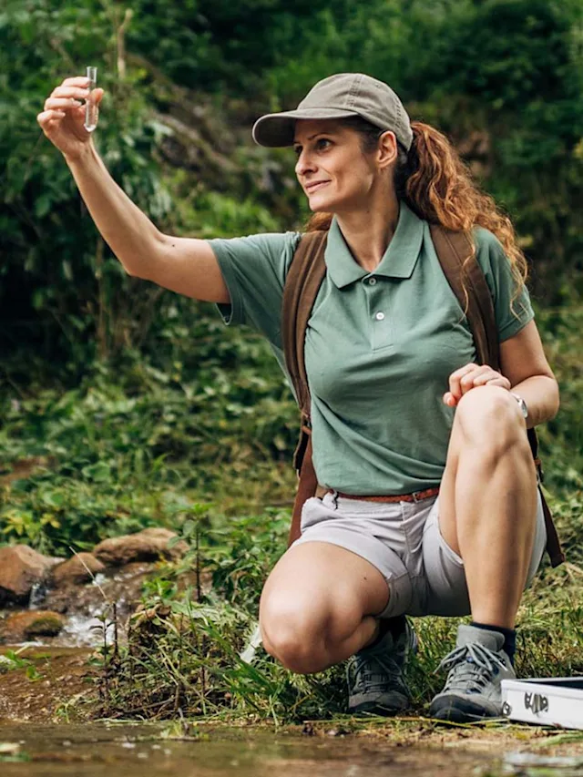 Woman researcher taking water sample