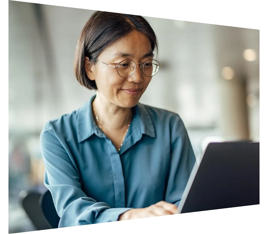 Confident asian woman working on laptop