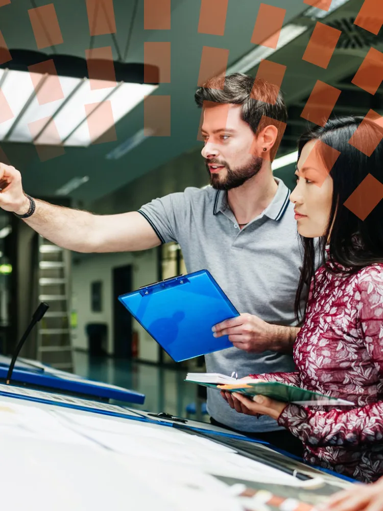 Male scientist wearing lab coat, looking away at the large screen.