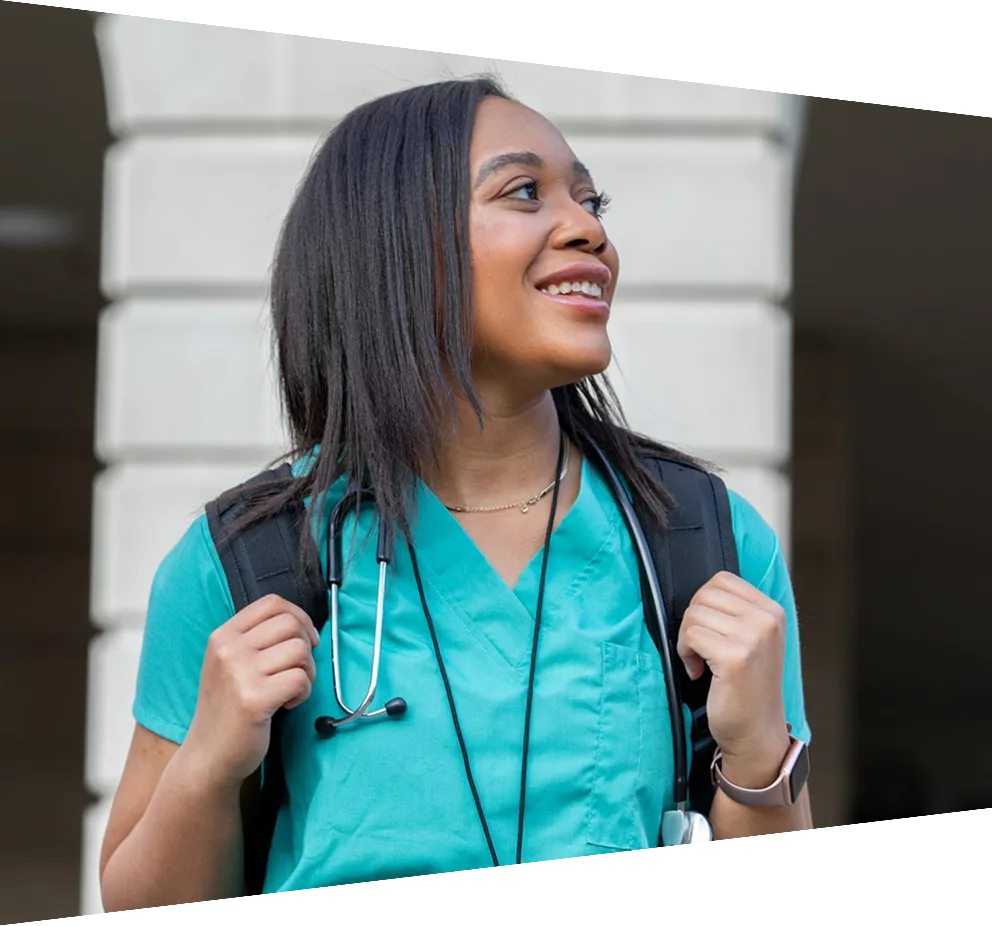 Smiling young African American woman walking on campus of nursing college