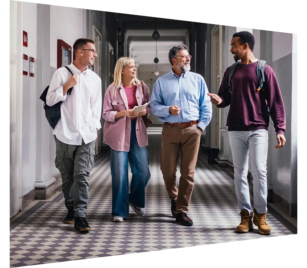 Diverse group of colleagues walking and talking to a professor in a hallway