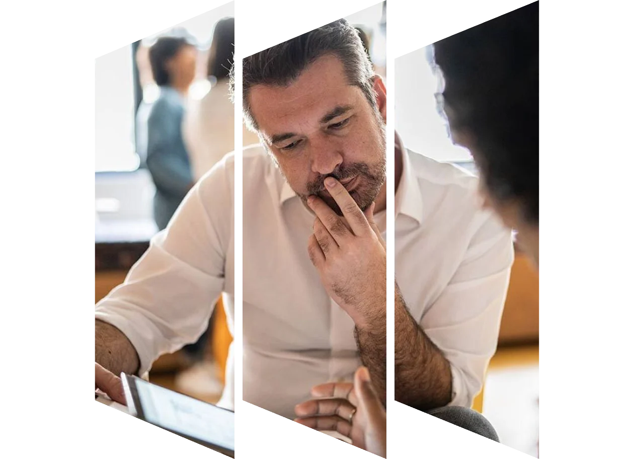 Man looking at tablet with colleague