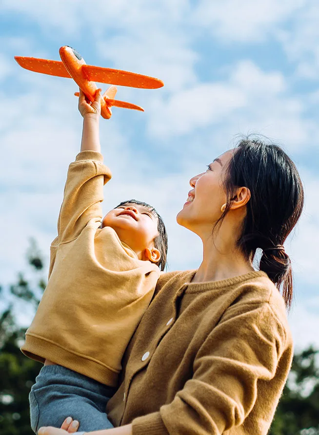 What if the most neglected conditions were the greatest source of hope? Mother carrying son, who is holding an airplane toy