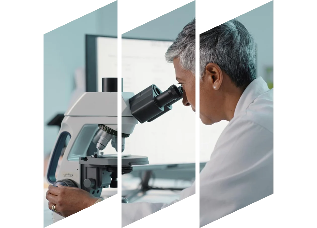 Male scientist looking into a microscope
