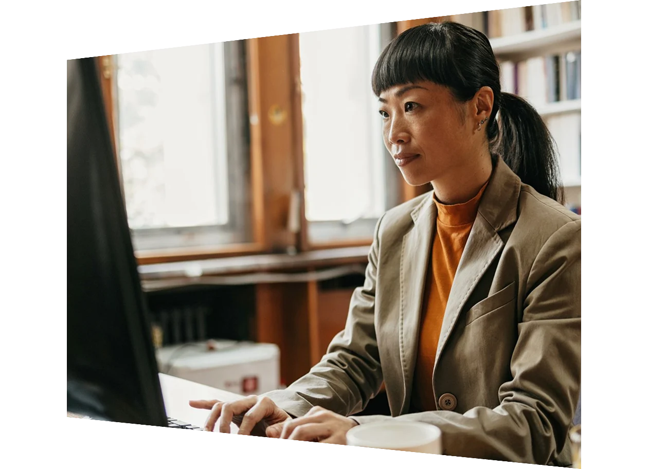 Mature man in suit working at desk in library