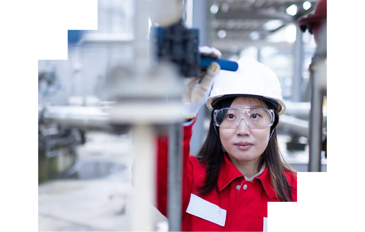 Woman and man on construction site holding laptops