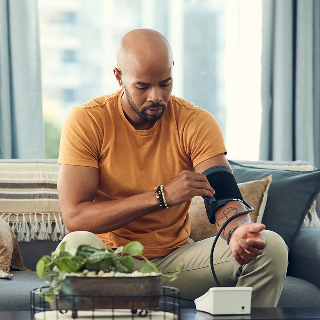 Man taking blood pressure at home