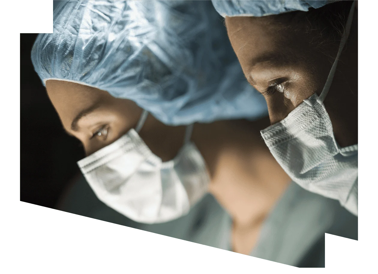 Two female surgeons wearing masks
