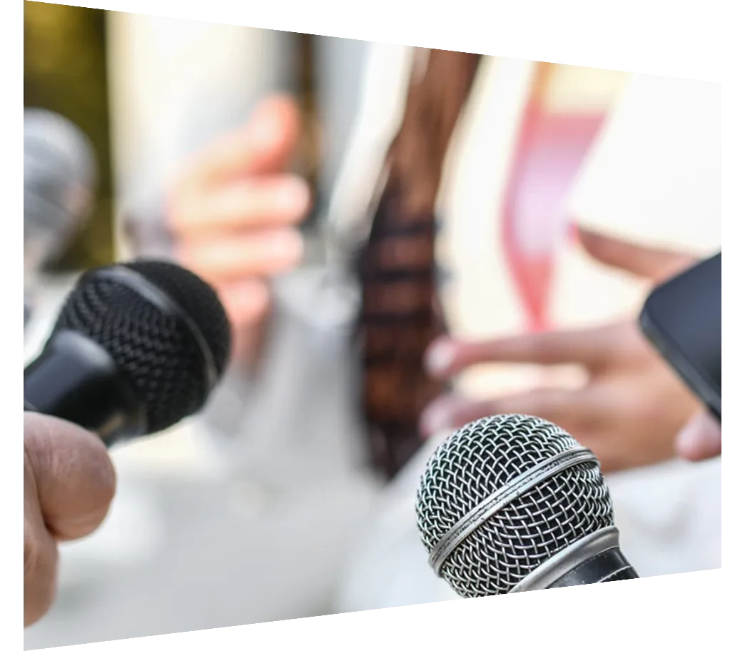 Microphones being held in front of woman talking