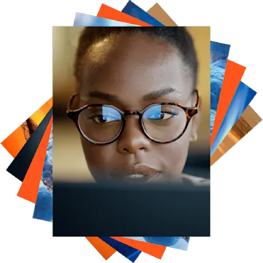 Woman looking at computer, reflection in her glasses