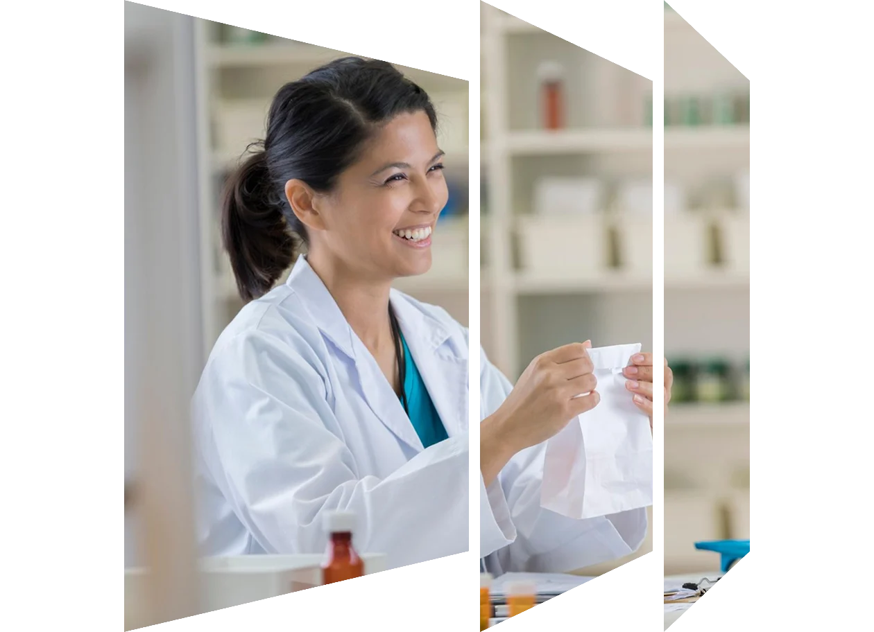 Smiling young pharmacist handing a customer her bag of medication