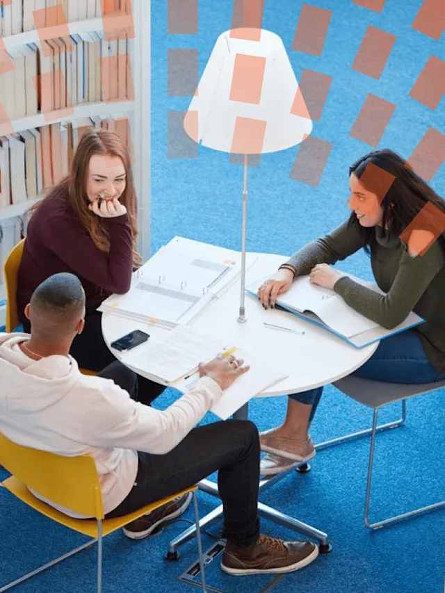 Students sitting around a table at library