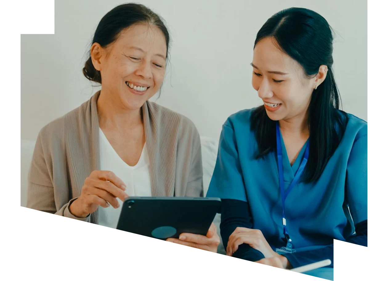 Home care healthcare professional using a digital tablet talking to a patient