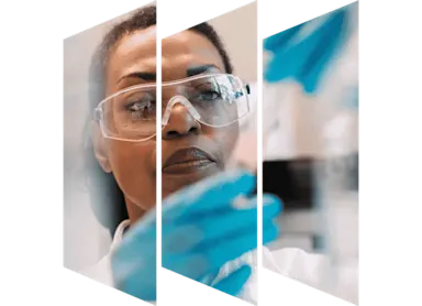 Female scientist looking at chemistry flask