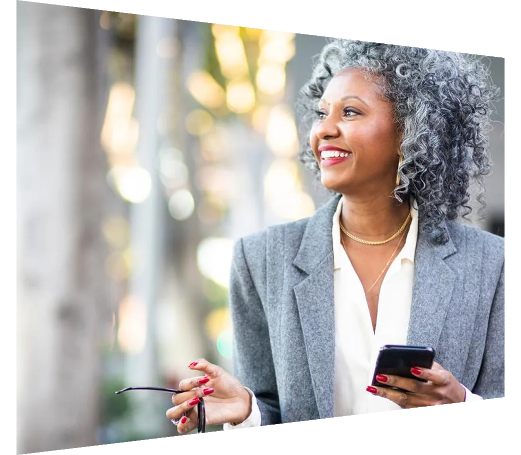 Mature Woman Texting While Walking in City