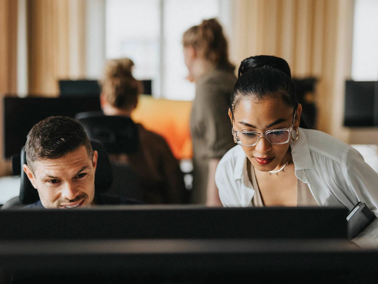 A man and a woman working at a computer (Maskot via Getty Images)