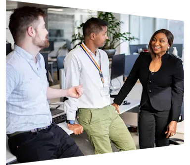 Sales, marketing and customer success team conversing in an Elsevier office