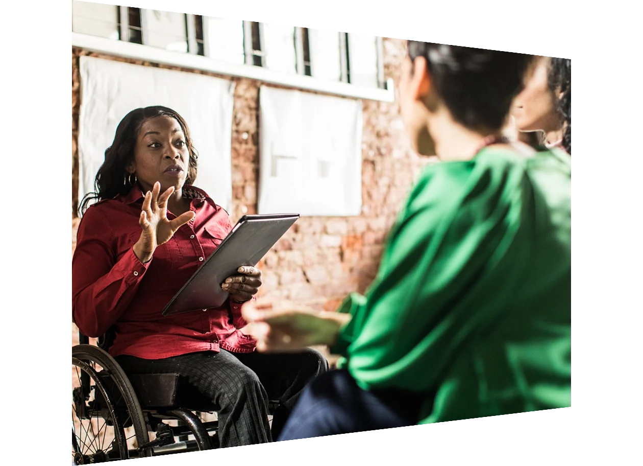 Woman in a wheelchair leading a meeting