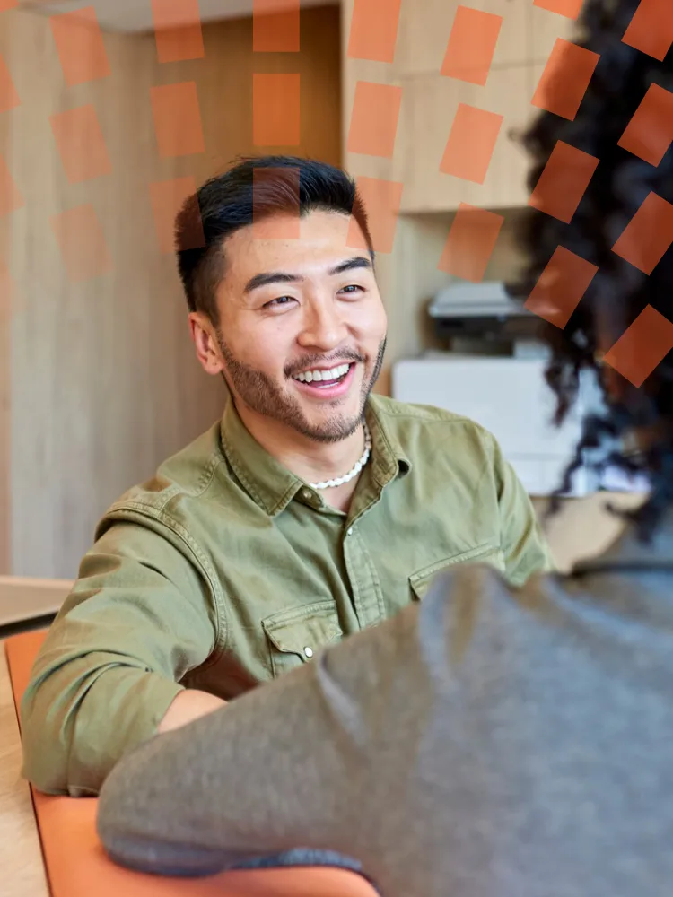 A smiling man wearing glasses, looking friendly and approachable.