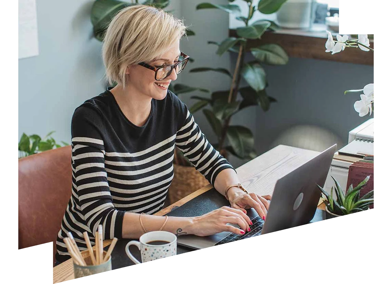 Woman watching webinar on her laptop in her home office