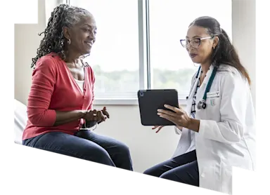 Stock image depicting a female physician showing a tablet to a patient (Source: MoMo Productions/DigitalVision via Getty Images)