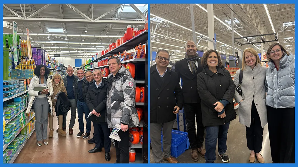 Two separate groups of adults, including men and women, are standing and smiling in a brightly lit retail store aisle with shelves stocked with various P&G brands.