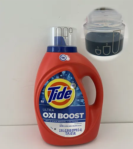 A bottle of Tide detergent with a cap made with laser marking technology