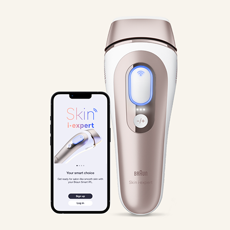 The white and beige Braun Skin i-expert handheld hair removal device stands upright. To the left of the device, a smartphone screen displays an image of the device, with instructional text and prompts.