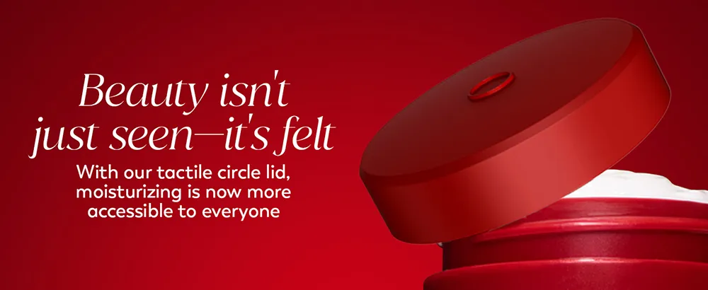 An open red jar of Olay Regenerist Moisturizer with a tactile cap