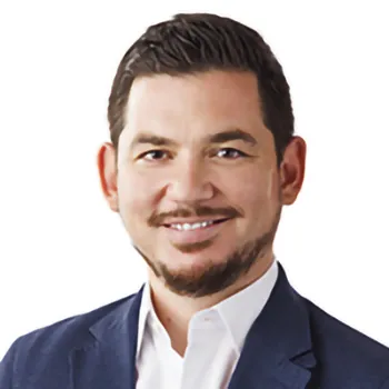 A man in a suit jacket and white shirt.
