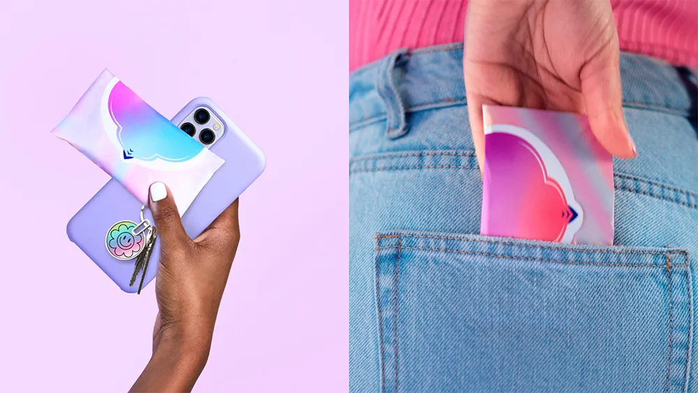 A hand holds a smartphone and Always period pad. To the right, a hand slips an Always period pad into a jeans pocket.