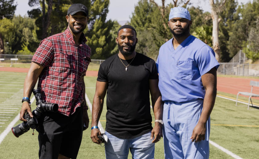 Isaiah Mustafa, Andrew Hawkins and Dr. Myron Rolle on set