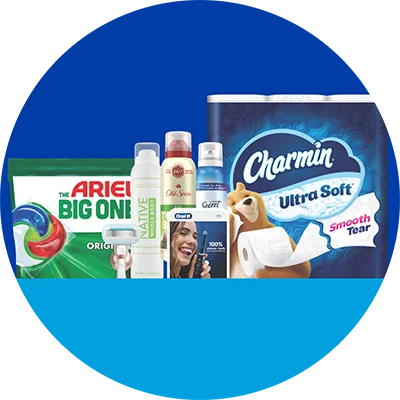 A box of dishwasher pods, razor, deodorant spray bottles and pack of toilet paper against a blue background.