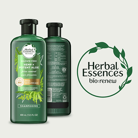 Herbal Essences bio: renew shampoo, a green bottle on a pale green background, displays front and back details with tactile symbols. The brand logo, "Herbal Essences bio: renew," is in a green circle with leaves beside the bottle.