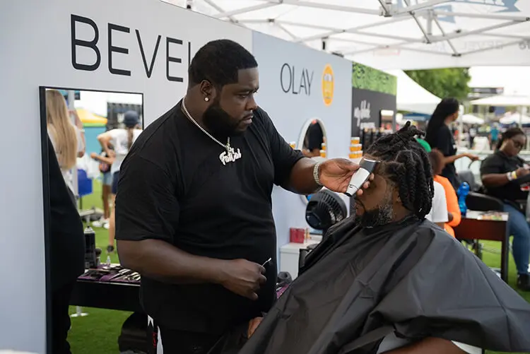 Bevel brand activation from ONE Musicfest, with student enjoying a grooming experience