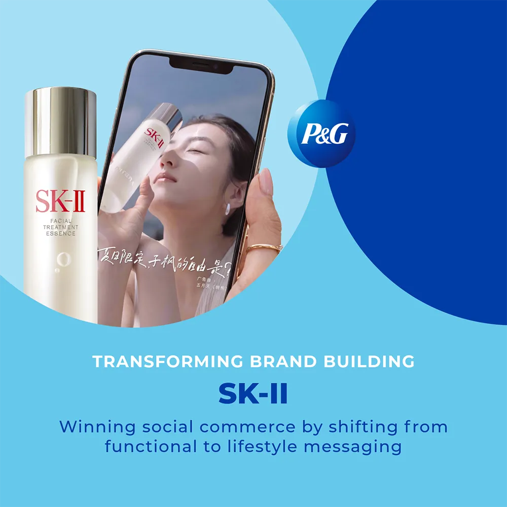 A bottle of SK-II Facial Treatment Essence next to a smartphone displaying an advertisement for the same product, featuring a woman with radiant skin.