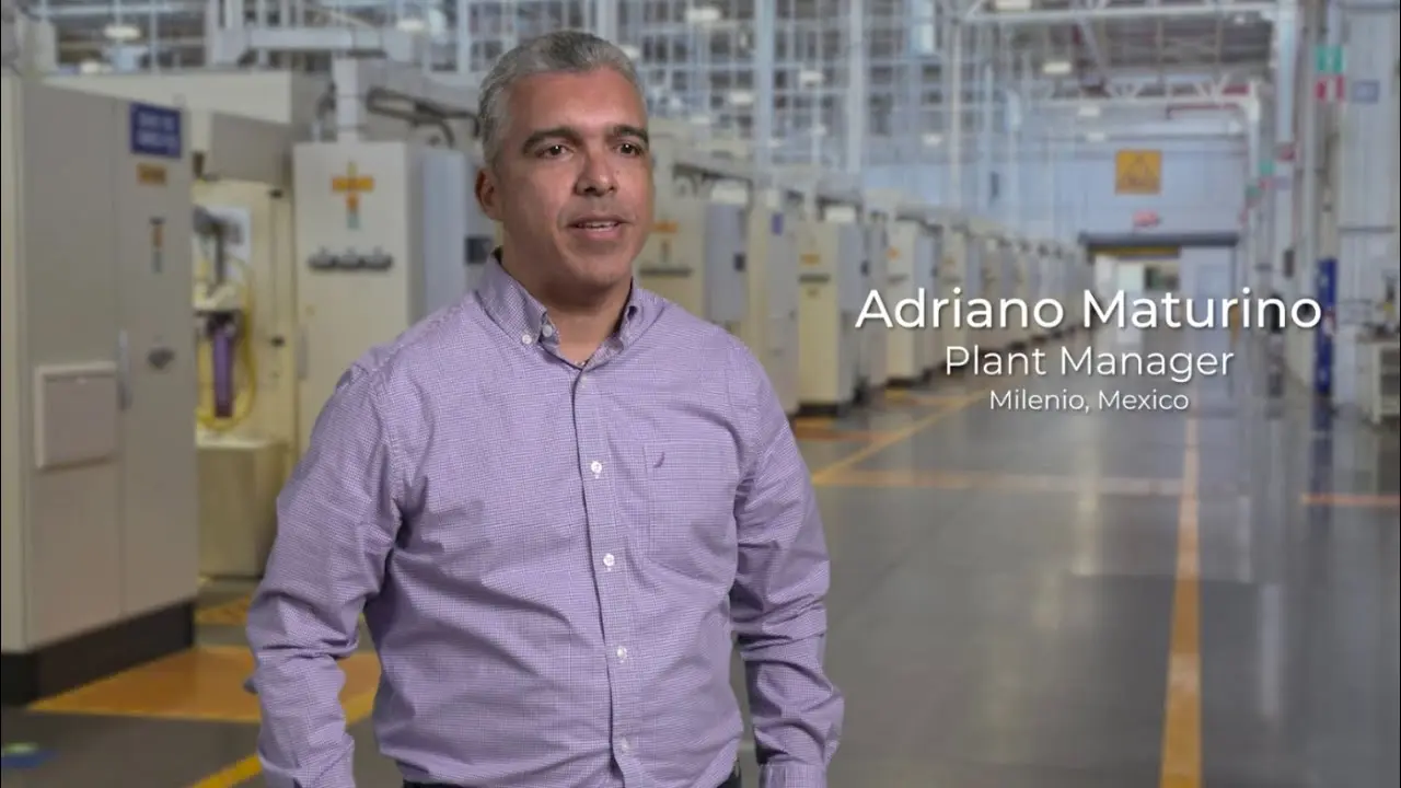 Plant manager standing in production line area with aligned industrial machines