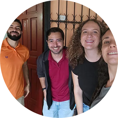 Two women and two men post together in front a home entryway.