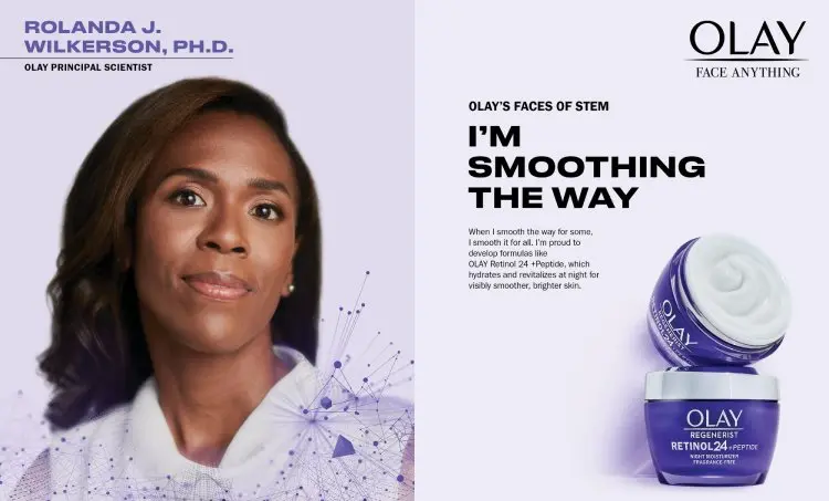 A Black woman with brown skin is wearing a lavender sweater and looks straight ahead. Two purple jars of Olay Regenerist are shown with text of product information. Text for Olay’s Faces of STEM initiative identifies Rolanda J. Wilkerson, Ph.D.