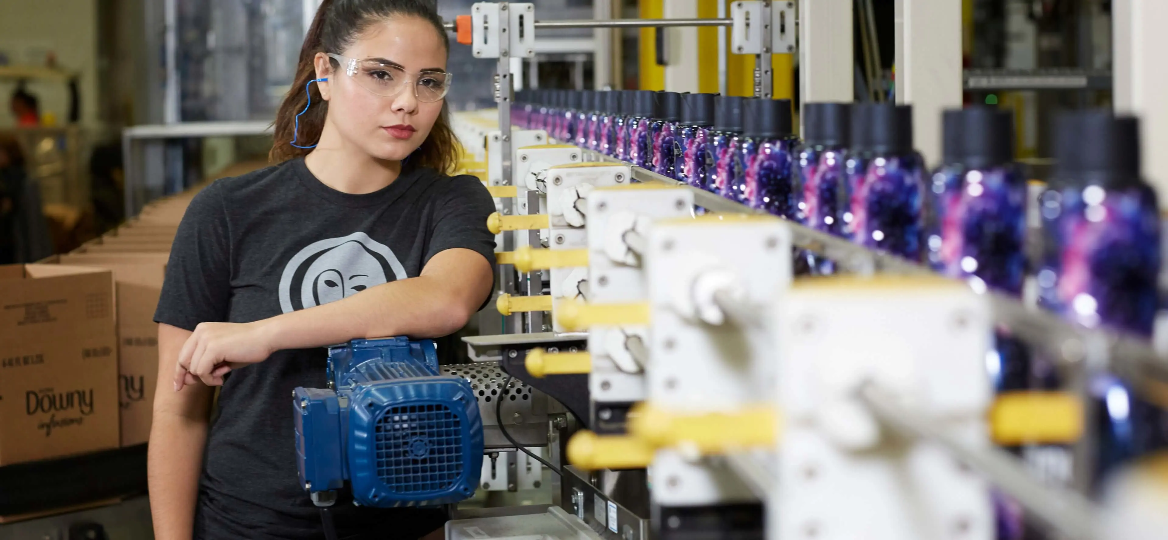 Female P&G plant employee oversees production line of Downy fabric softener