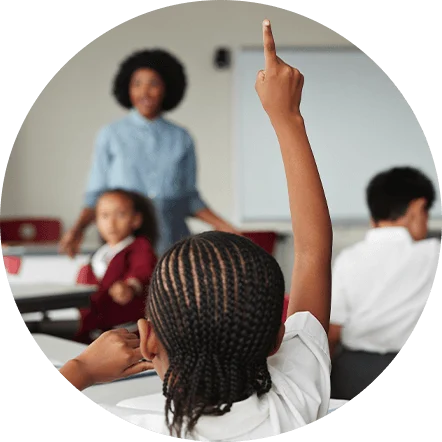 Black boy raising hand in class